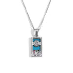 Silver pendant with 'The Sun' design on a white background