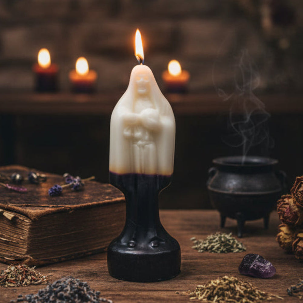 A religious taper candle shaped like the Virgin Mary, with a cream-colored upper body and a dark black lower base, isolated on a white background.