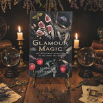 Book titled 'Glamour Magic' by Deborah Castellano with decorative elements on a dark background.