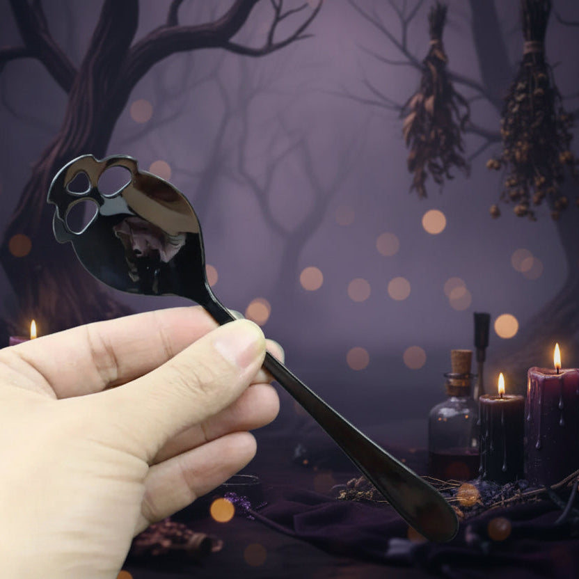 A hand holding a dark brown spoon with a paw print cutout in the bowl, set against a dark gray background.