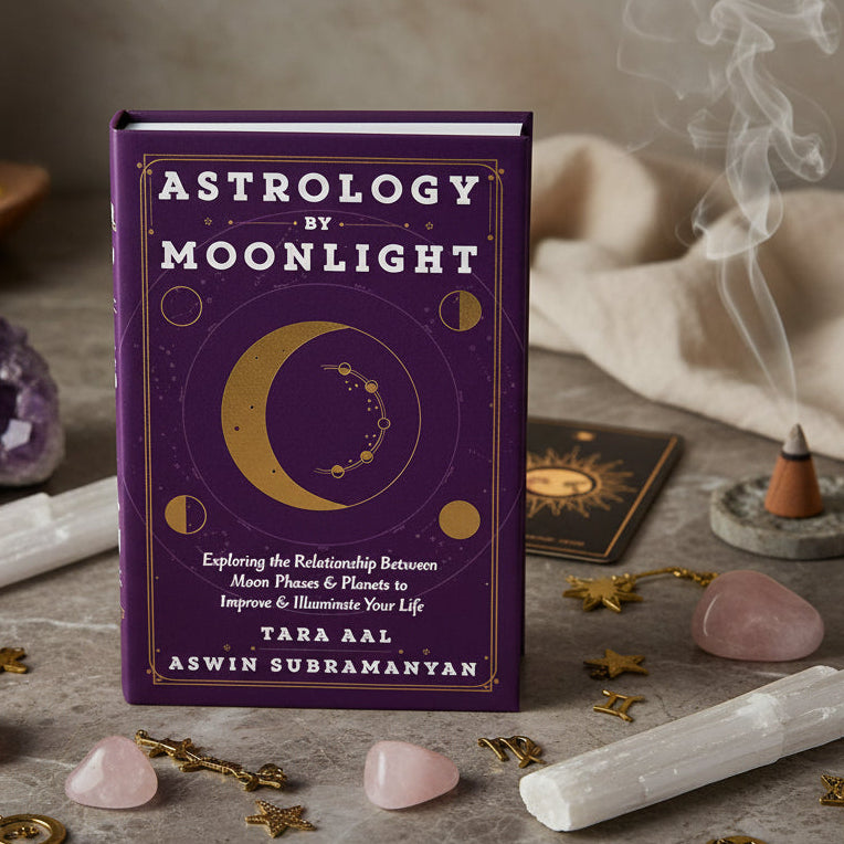 Book cover of 'Astrology by Moonlight' with celestial design on a purple background