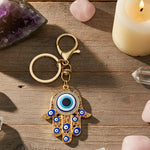 Keychain with Hamsa hand design featuring an evil eye on a white background