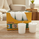 White candles in a box labeled 'White Sage' with a visible brand logo.