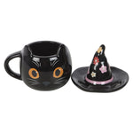 Black cat-shaped mug with a decorative witch hat on a white background