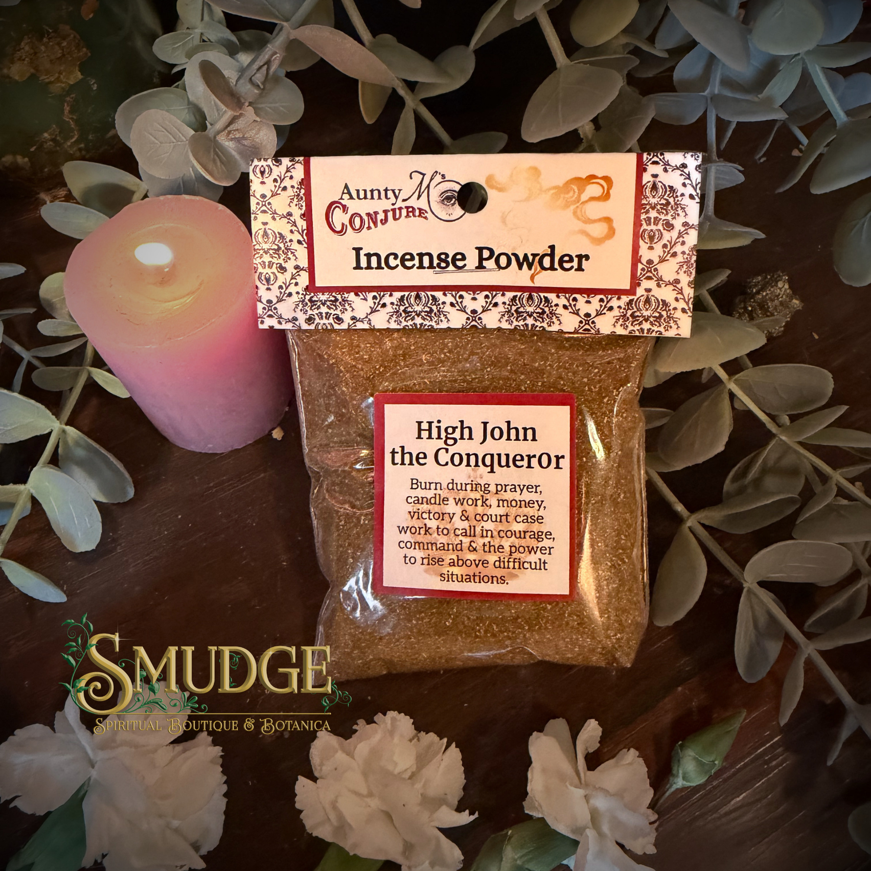 Packaged HIgh John  incense powder with a label on a wooden surface with flowers and a candle.