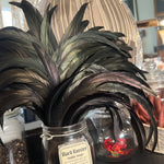 Bottle with feathers in the foreground