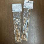 Herbal roots in a clear plastic bag with labels on a wooden surface