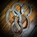 Old horseshoes on a wooden surface