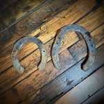 Rusty horseshoe on a wooden surface