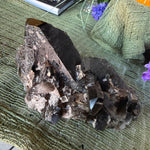 Mineral specimen on a green fabric background with decorative elements