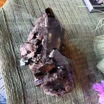 Mineral specimen on a textured surface with a blurred background