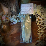 Packaged leaves on a wooden surface with decorative elements