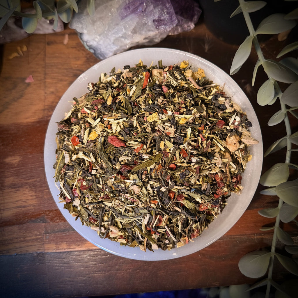 Herbal tea  flu fighter in a white bowl on a wooden surface with plants and crystals in the background