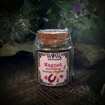 Small glass jar with a decorative label on a textured surface with green leaves in the background