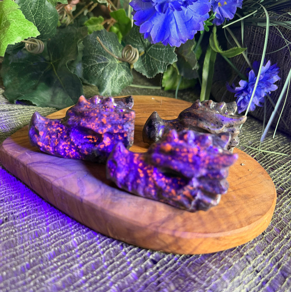 Wooden heart-shaped box with purple coral-like objects on a textured purple background