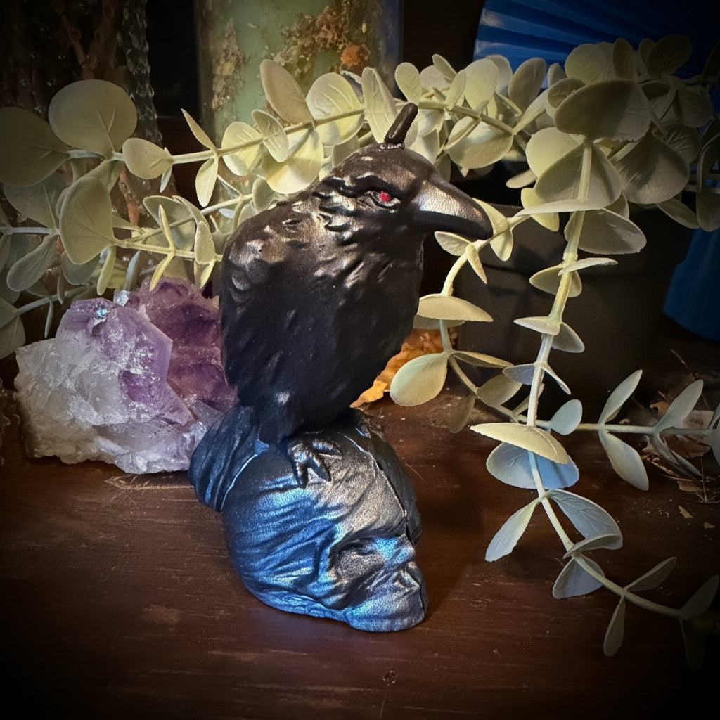 Decorative setting with birds, leaves, and a purple crystal on a wooden surface.
