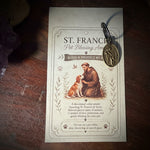 Vintage-style card with religious imagery on a wooden surface with crystals and herbs.