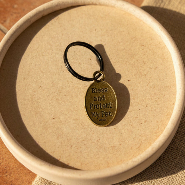 Keychain with 'Bless and Protect My Pet' tag on a ceramic dish