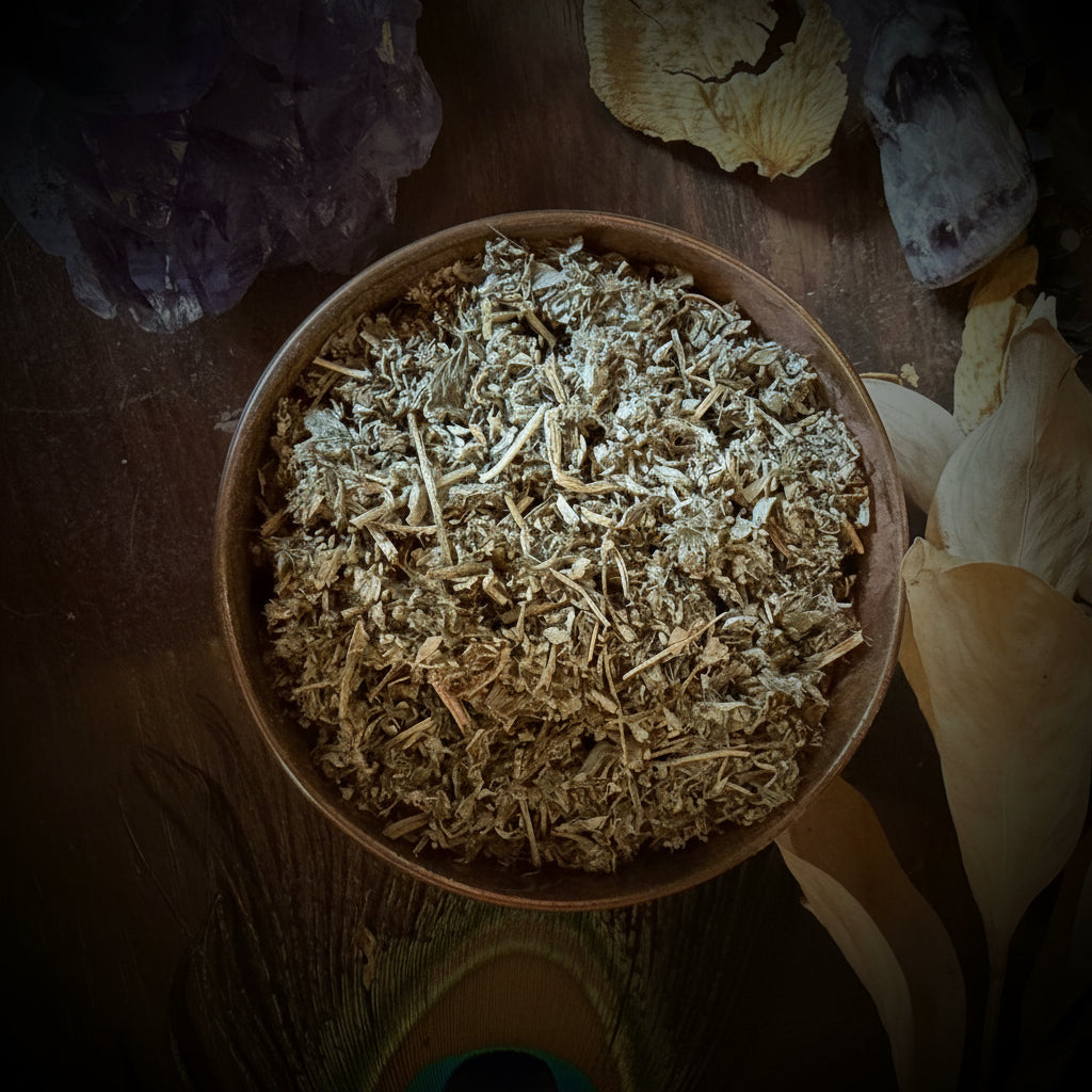 Bowl of dried herbs on a wooden surface with crystals and stones