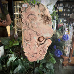 Decorative stone with greenery and flowers on a table