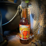 Bottle of Colonia Santo Tabacco on a wooden surface with a blurred background