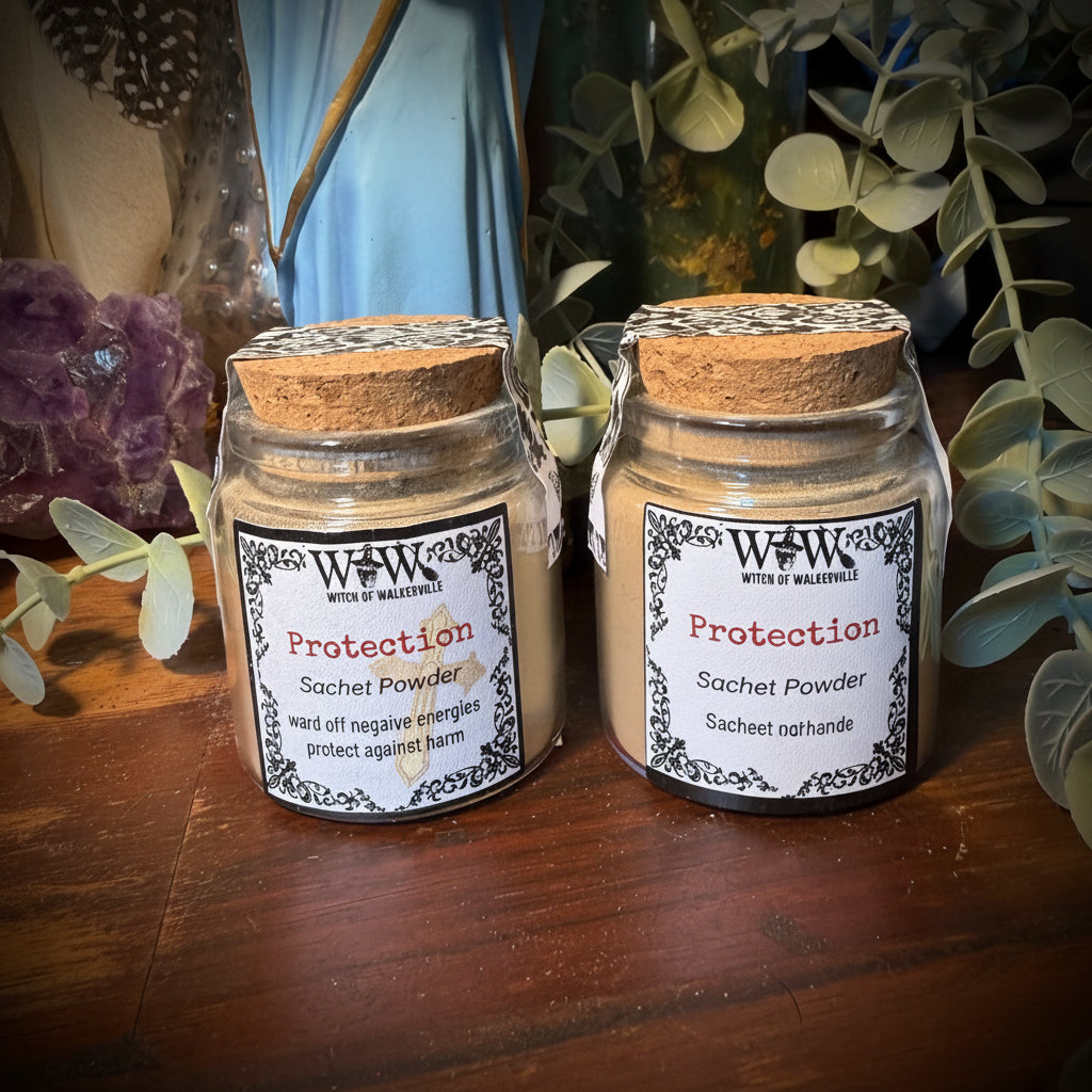 Two small jars with labels on a wooden surface with decorative elements.