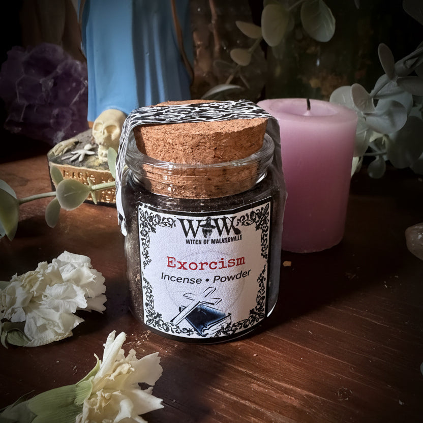 Small jar with a label on a wooden surface with flowers and plants.