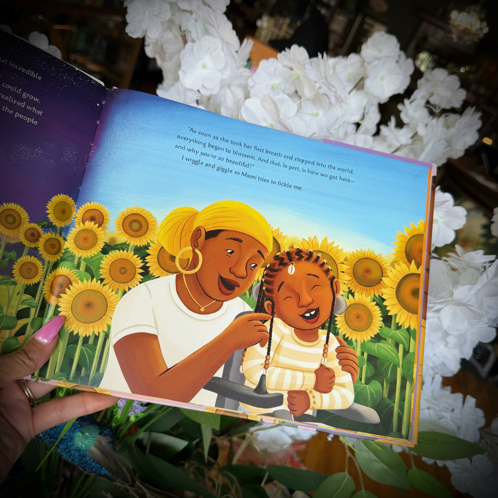 A mother and daughter laughing and hugging in front of sunflowers. 