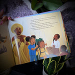 children's story book with a group of children playing with Ochun behind them.