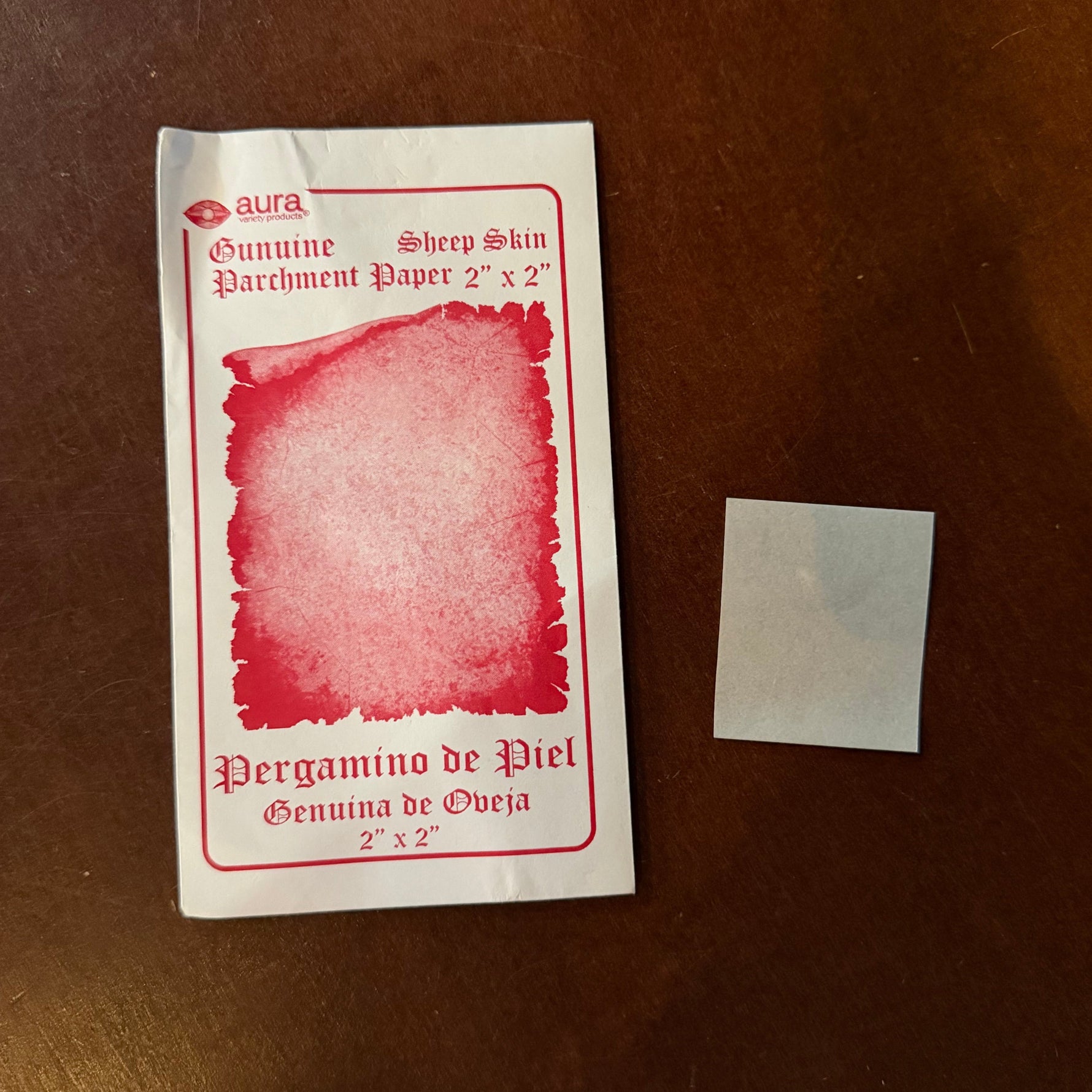 A Sheepskin parchment paper on a wooden table. The package says 2 inches square.
