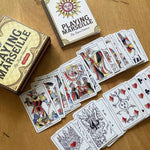 Playing Marseille cards and packaging on a wooden surface