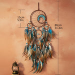 Dreamcatcher with feathers and measurements on a plain background