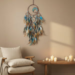 Decorative dreamcatcher with feathers on a light background