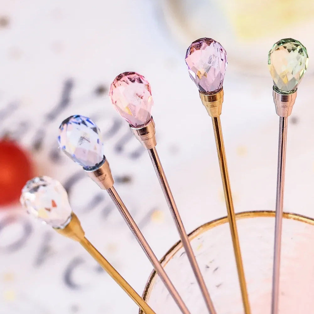 Set of decorative cocktail sticks with crystal tips on a blurred background