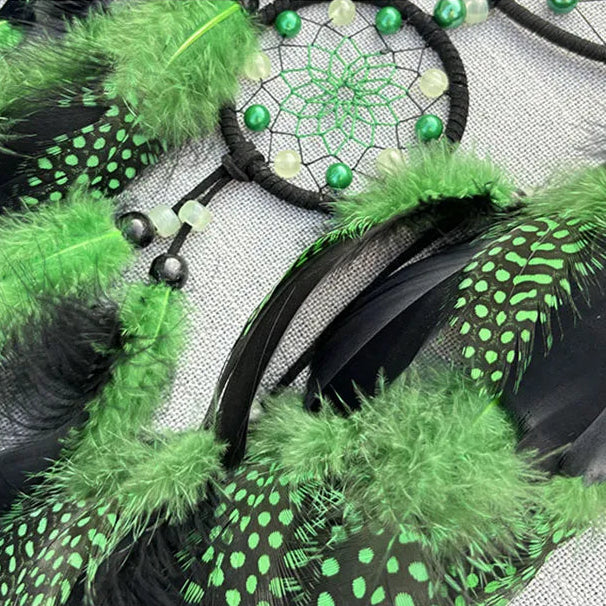 Green and black feathered product with a dreamcatcher design on a white background.
