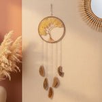 Decorative wall hanging with stones and lights on a white wall