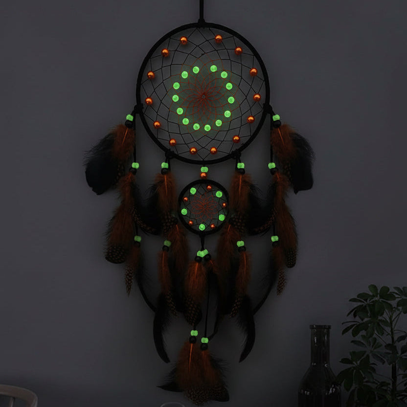 Decorative dreamcatcher with glowing beads on a wall.