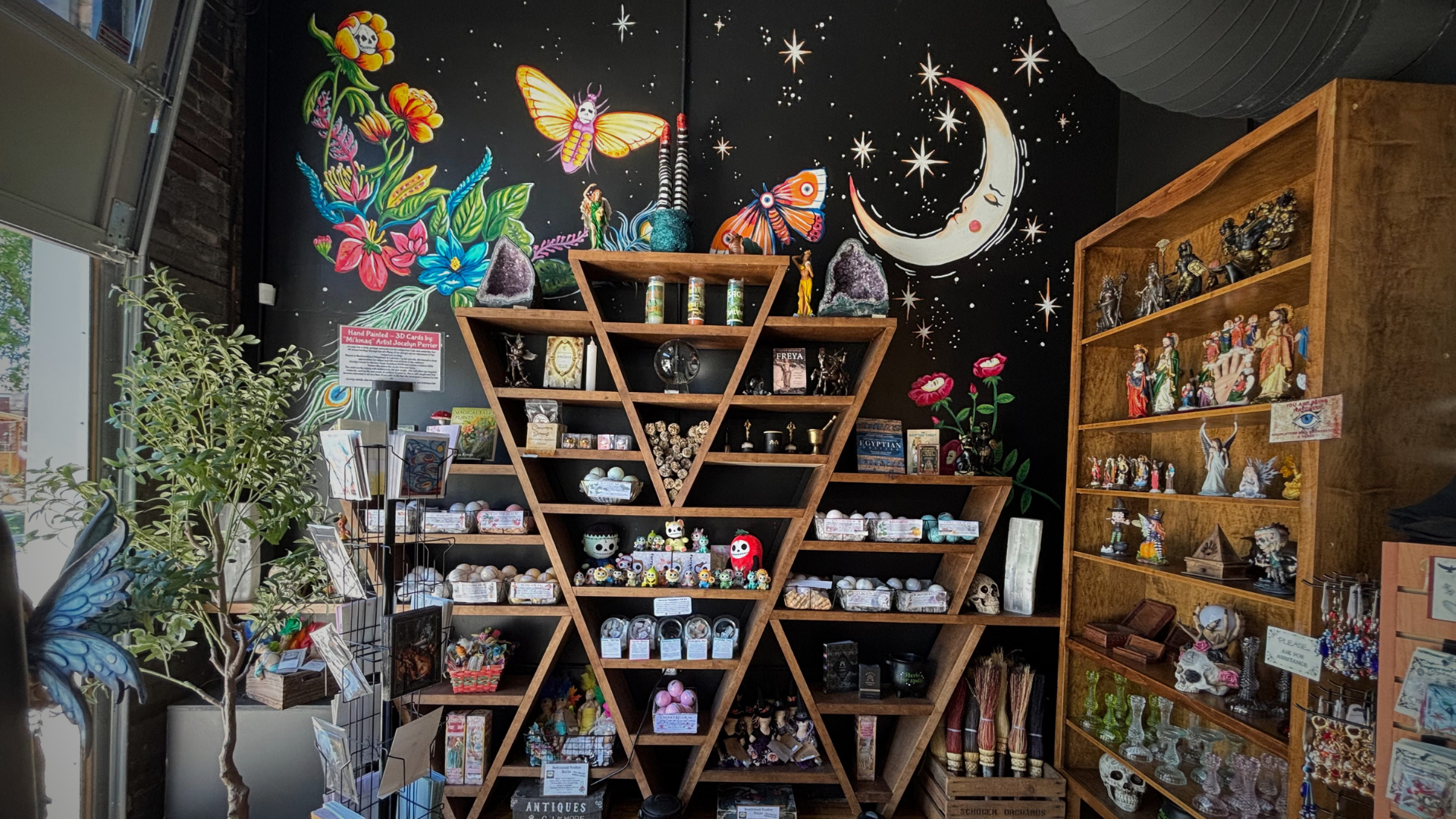 Wooden shelves with various decorative items against a dark wall with star and moon designs.
