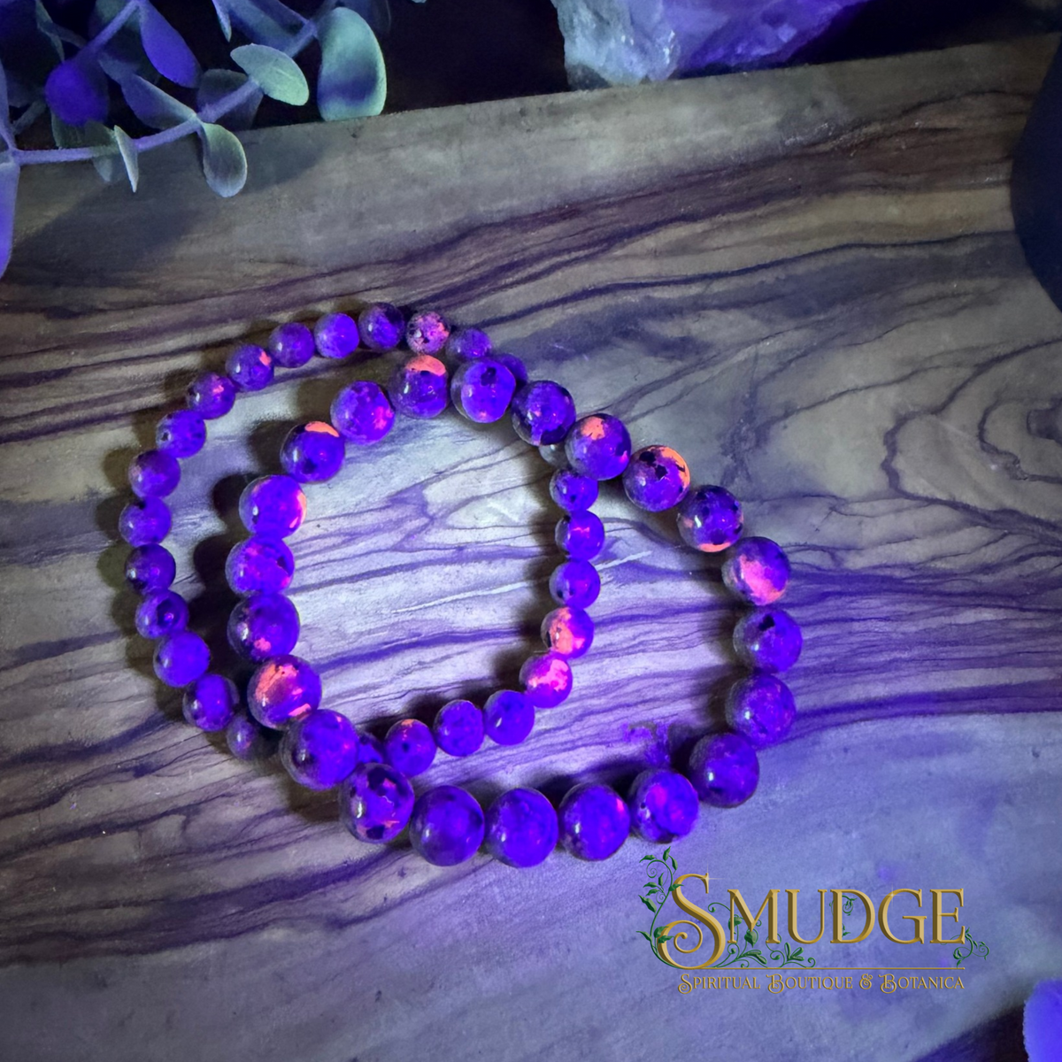 glow in the dark yooperlite bracelets on a wooden background
