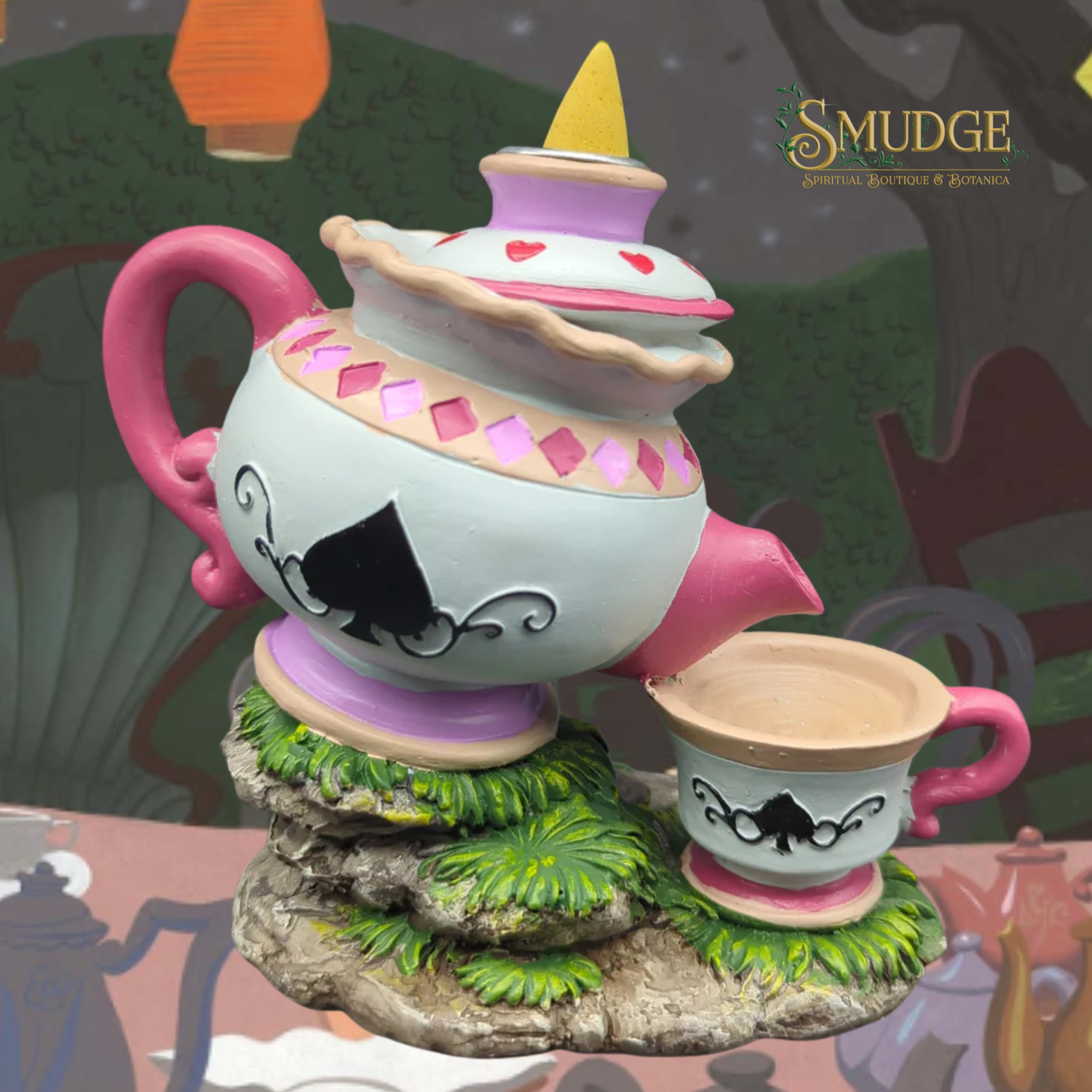 Decorative teapot and cup set with a cartoonish design on a whimsical background.
