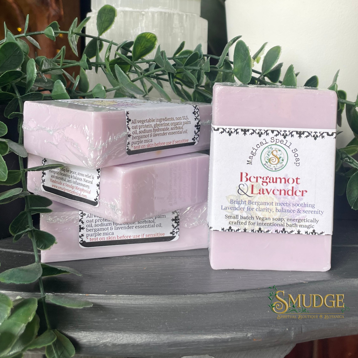 Bergamot & Lavender soap bars with packaging on a surface with greenery in the background