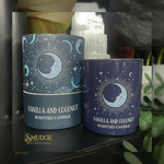 Two 'Vanilla and Coconut Scented Candle' containers with celestial designs on a dark surface.
