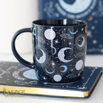 Celestial patterned mug sitting on notebook