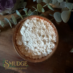 Cascarilla powder in a copper bowl on a table.