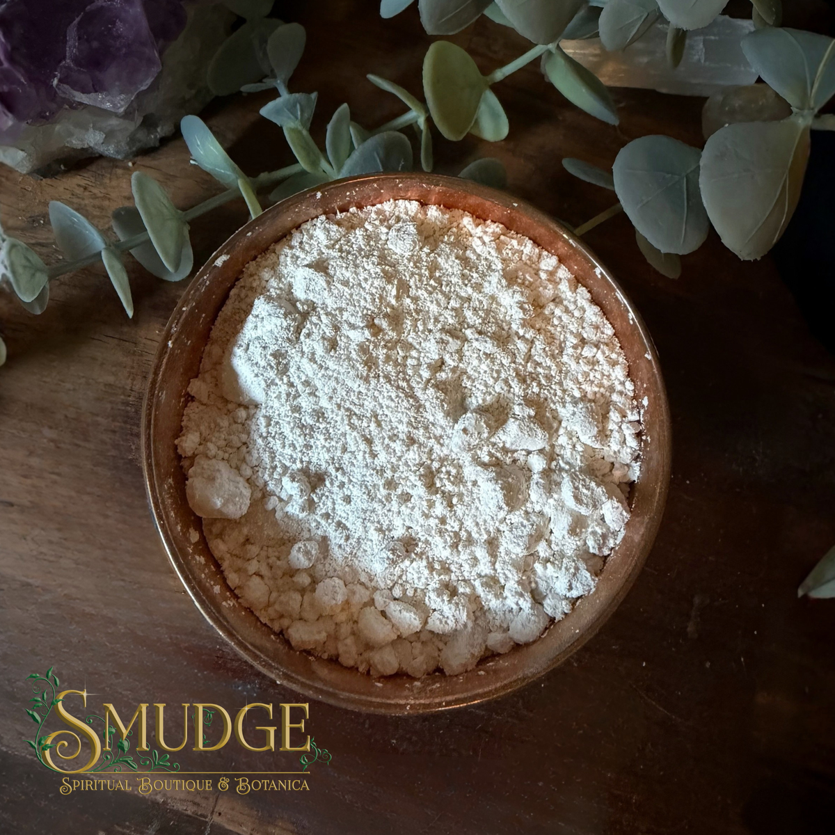 Cascarilla powder in a copper bowl on a table.