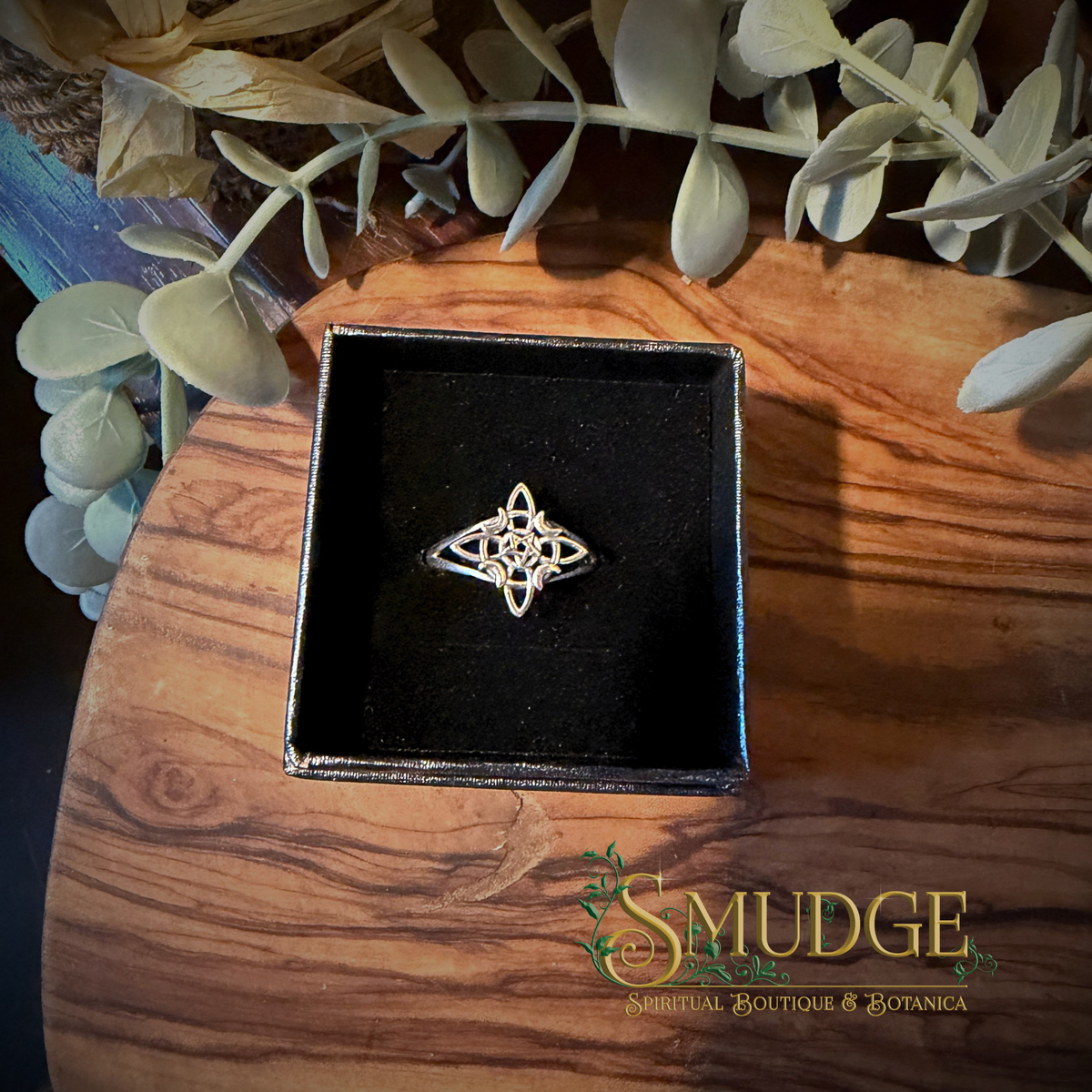 silver ring with a celtic not, pentacle and crescent moons in a black ring box.