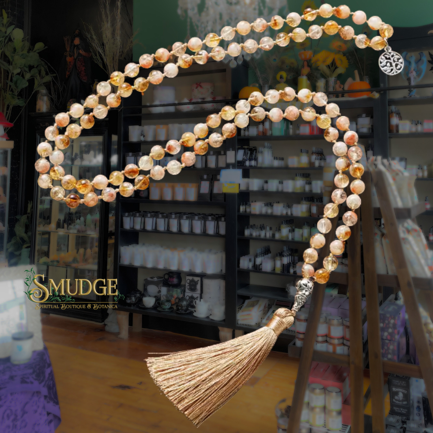 Necklace with beads and tassel in a store setting, featuring the brand 'Smudge'.