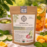 Wellness tea package with cucumber melon flavor on a table with tea and ingredients.