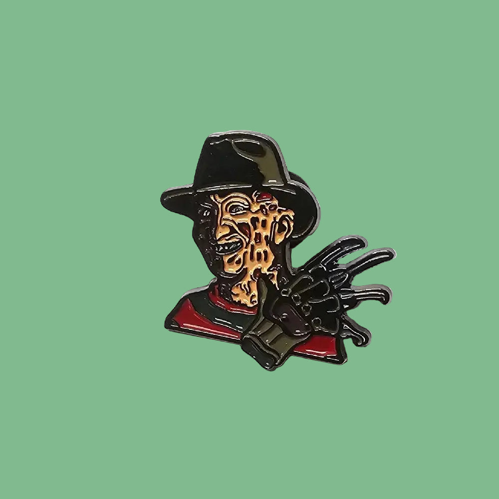 Metallic Freddy Krueger pin with a white background