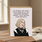 Card with illustration of a woman and humorous birthday message on a plain background